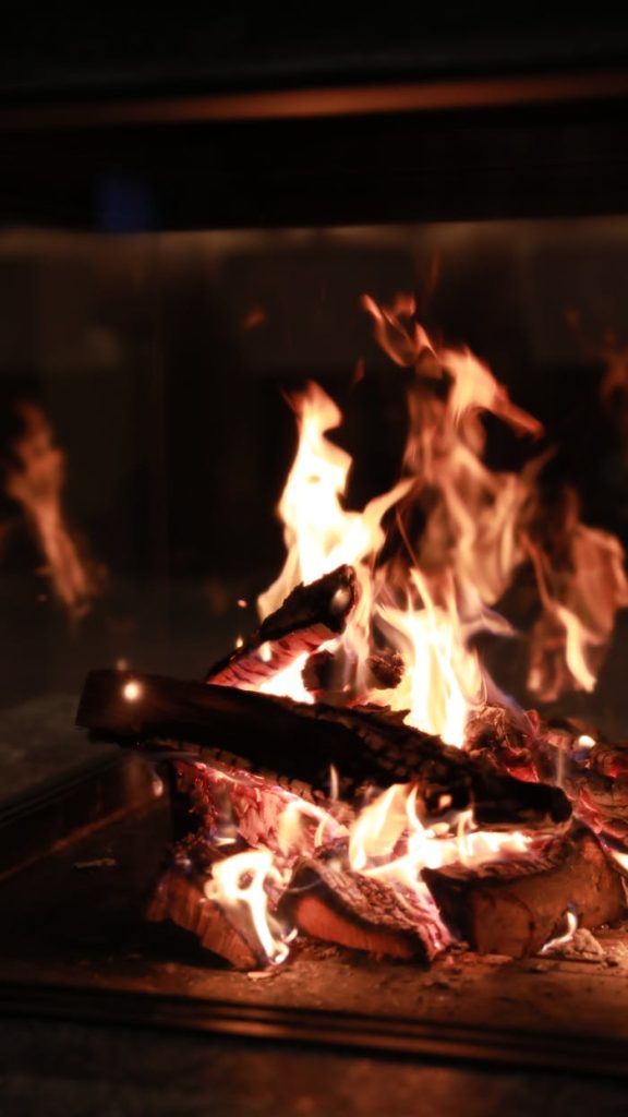 Warm, glowing flames of a fireplace create a relaxing indoor ambiance in New York.