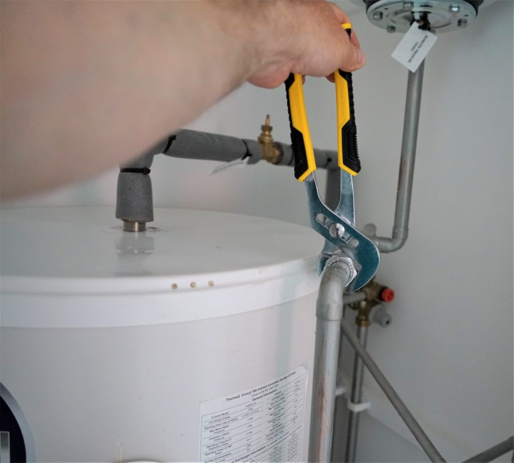 person-holding-yellow-and-gray-hand-tool-c-oyjoifgcs